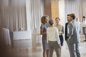 legal recruiters standing in conference room, talking and smiling